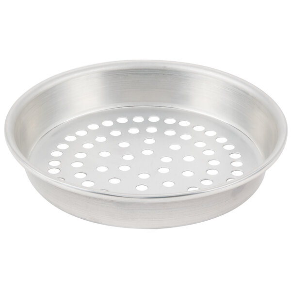 A silver round metal pan with holes.