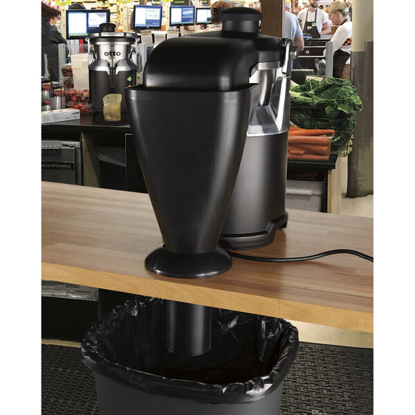 A Hamilton Beach black juicer with an under-counter pulp chute.