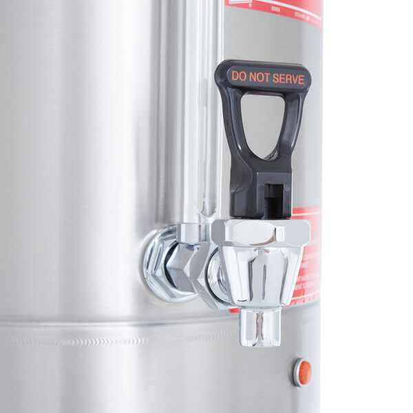 A Grindmaster stainless steel hot water boiler with a faucet.