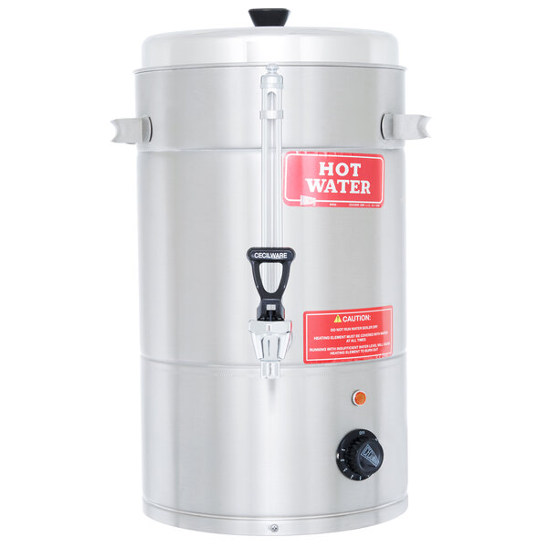 A stainless steel Grindmaster hot water boiler with a red label on the silver water tank.