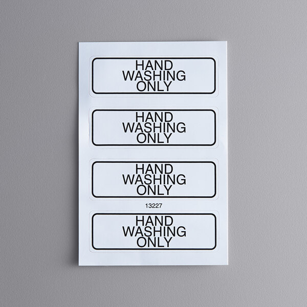 A group of white rectangular signs with black text reading "Hand Washing Only" and "Cambro"