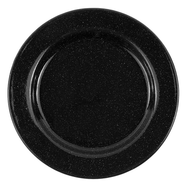 A black Crow Canyon Home enamelware plate with a speckled surface and black rim.