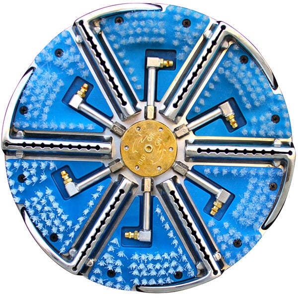 A circular stainless steel cleaning head with four screws and many metal parts.