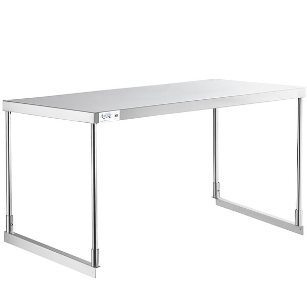 An Avantco stainless steel single deck overshelf on a white table with metal legs.