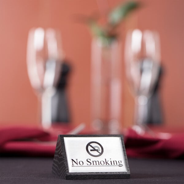 An American Metalcraft black wood "No Smoking" sign on a table.