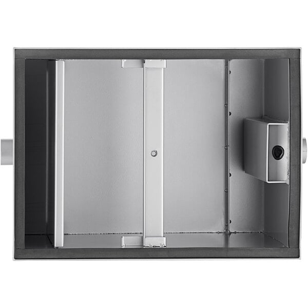 A metal box with a rectangular object in the middle and a door open.