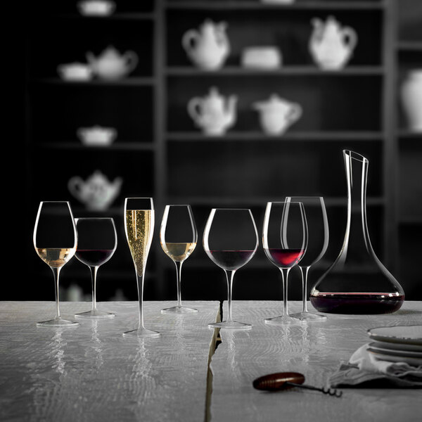 A table with Luigi Bormioli Vinoteque spirits snifters filled with red wine.