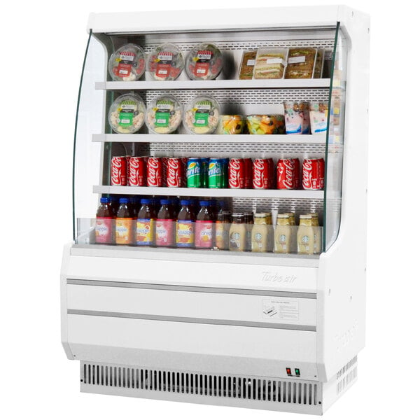 A white Turbo Air air curtain merchandiser with food and drinks on display.