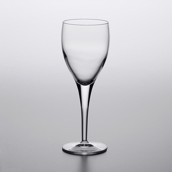 A clear Luigi Bormioli Michelangelo red wine glass on a white surface.