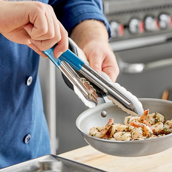 A person holding Carlisle stainless steel tongs with a blue Dura-Kool handle over a bowl of shrimp.