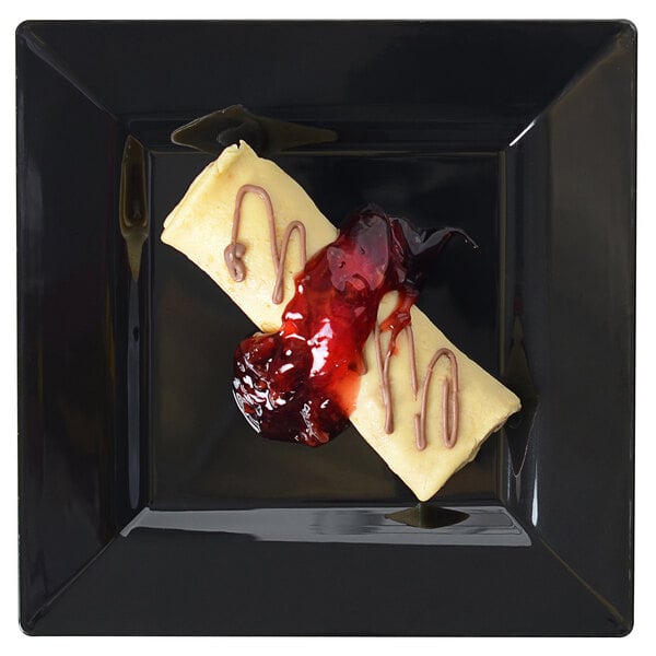 A Fineline Settings black square dessert plate with food on it.