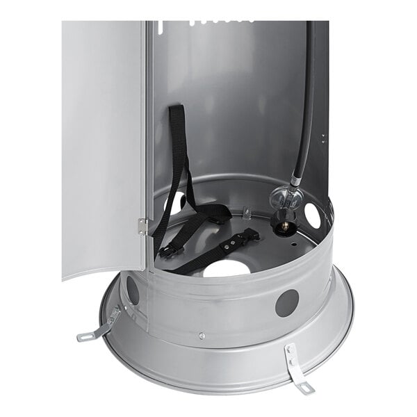 A steel base compartment of a round portable propane outdoor patio heater with an open door, showing internal straps and a gas hose connection.