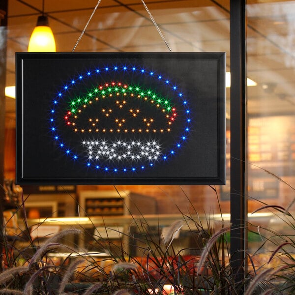 A white LED rectangular sign that says "Tacos" with lights on it.