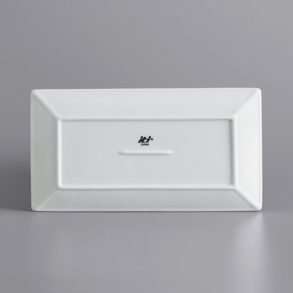 A white rectangular International Tableware porcelain platter with a white border and black text.