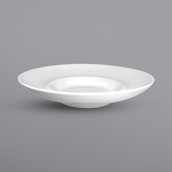 A close up of a white International Tableware Bristol wide rim porcelain bowl.