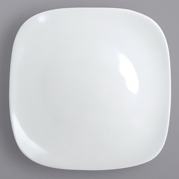 A white International Tableware square porcelain plate.