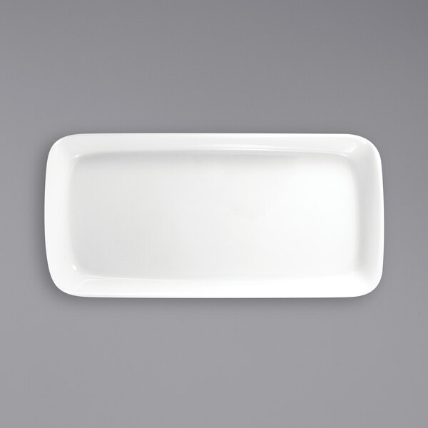 An International Tableware rectangular white porcelain platter on a gray surface.