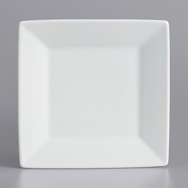 A white square porcelain plate with a white rim.