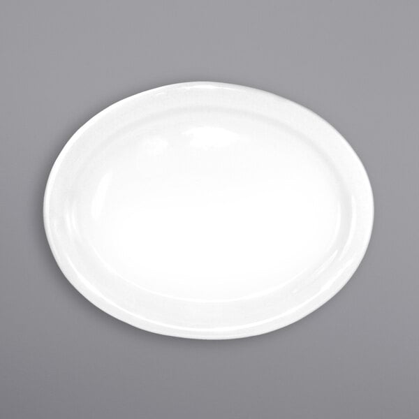 An International Tableware white porcelain platter with a narrow white rim on a gray surface.