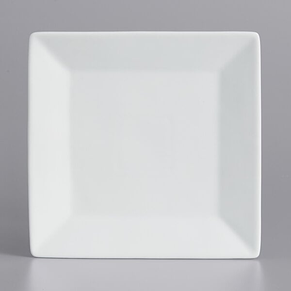 A white square porcelain plate with a white rim.