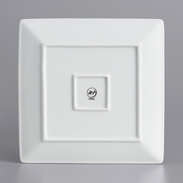 A bright white square porcelain plate with a wide rim.