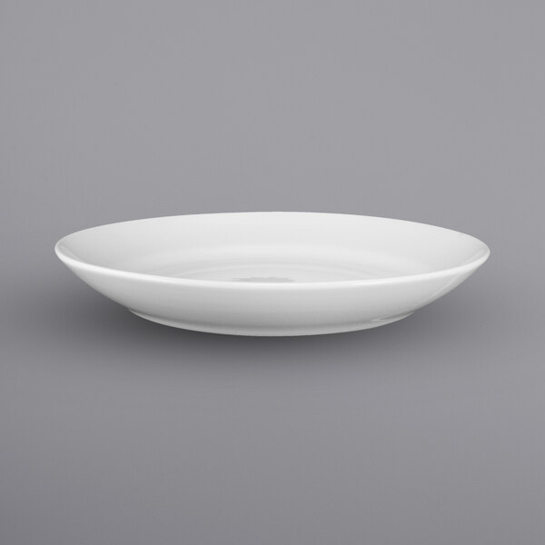 A close up of a white International Tableware porcelain stadium bowl with a small rim.