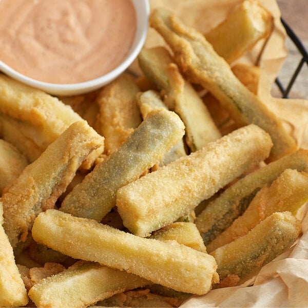 Golden Dipt All-Purpose Breading fried green beans in a basket with dipping sauce.