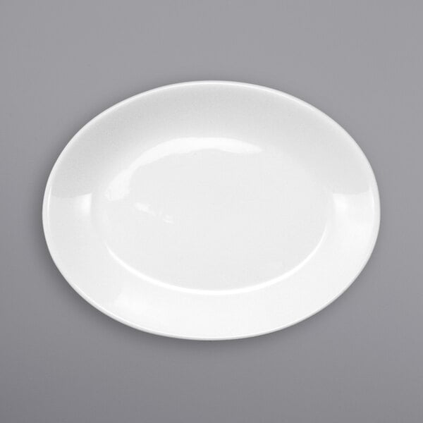 An International Tableware white porcelain platter with a white rim on a gray surface.