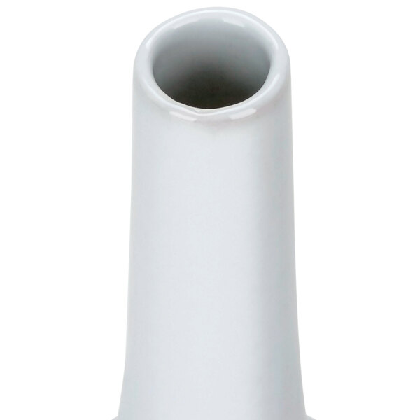 A European white porcelain bud vase with a small hole in the bottom.