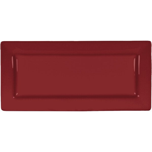 A red rectangular International Tableware porcelain platter with a white rim.