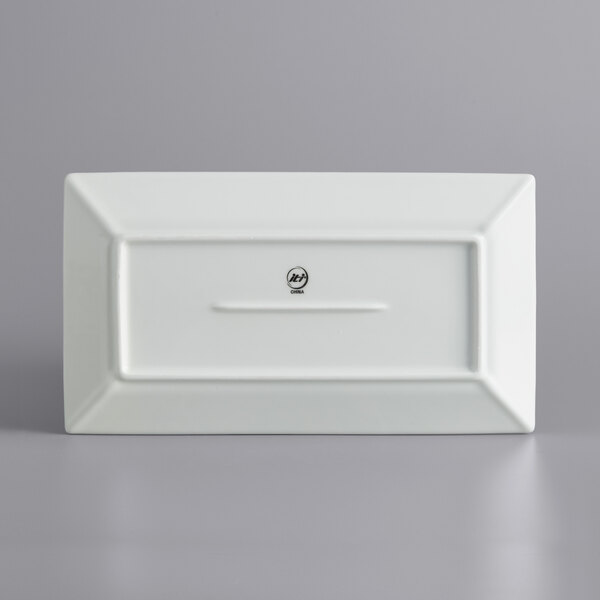 A white rectangular porcelain platter with a wide rim.