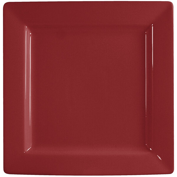 An International Tableware square porcelain plate with a red surface and white border.