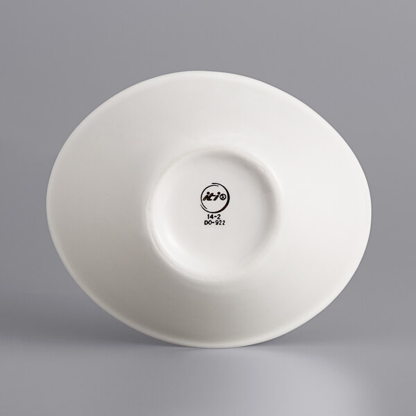 A white International Tableware oval porcelain bowl with a curved rim.