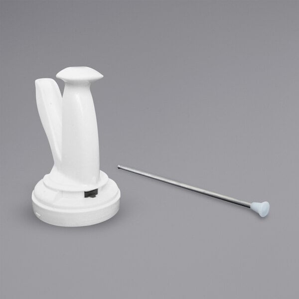 A white plastic spoon and a long metal object with a white base.