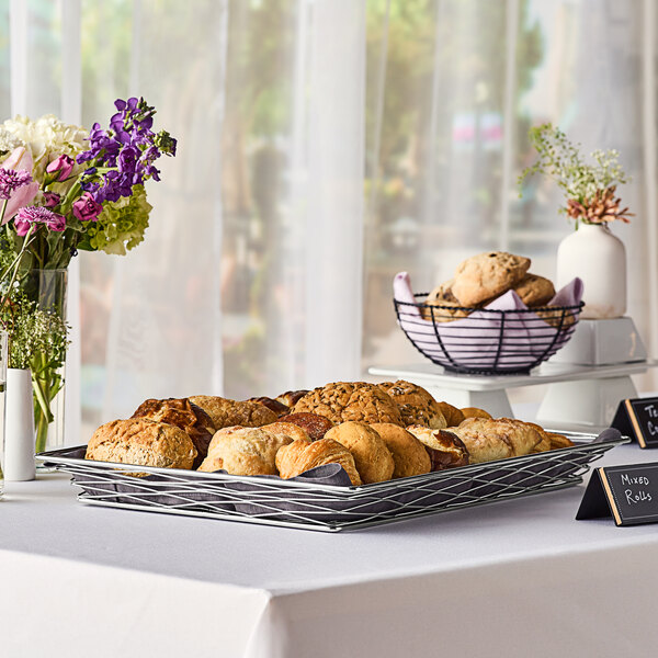 An American Metalcraft chrome wire basket filled with pastries.