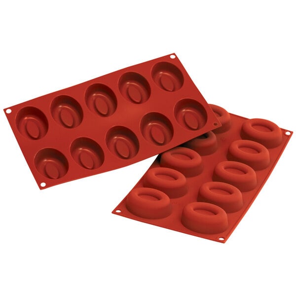 A red silicone Silikomart baking mold with oval cavities.