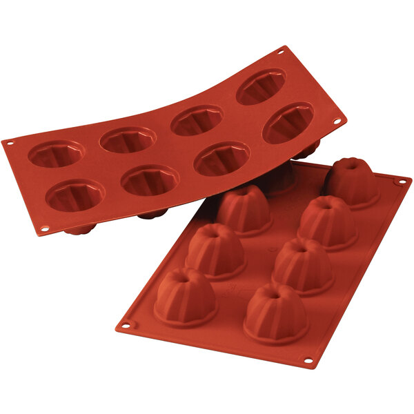 a red silicone baking tray with small round molds