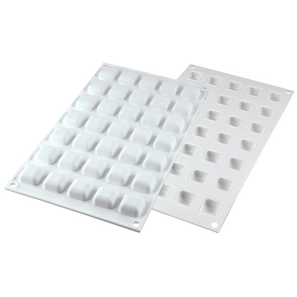 A white Silikomart silicone baking mold tray with 35 small rectangular compartments with borders.