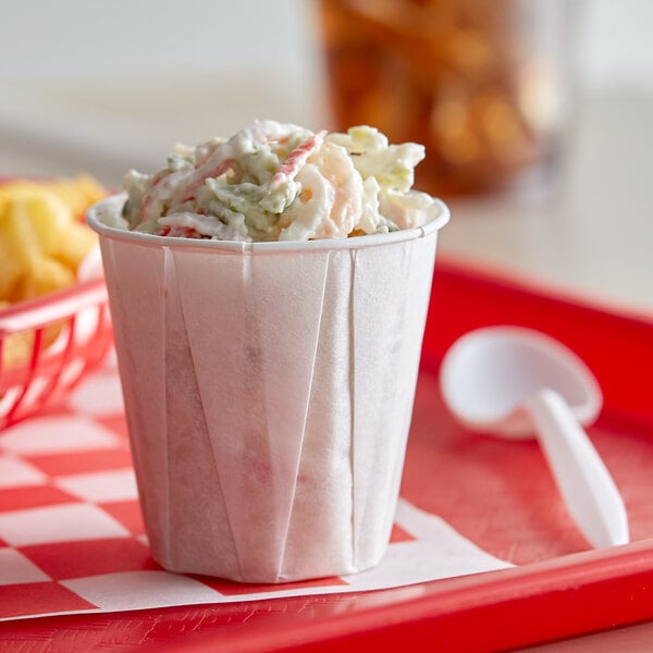 A small cup of crab salad on a table.