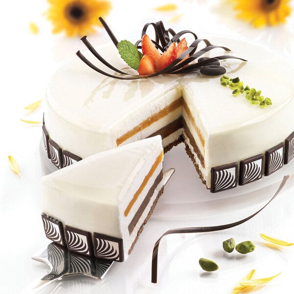 A white cake with a slice cut out of a Silikomart silicone baking mold.