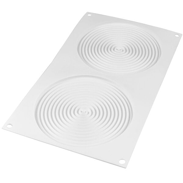 A white silicone baking mold with circular spiral designs.