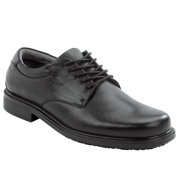 A black Rockport Works men's leather dress shoe with laces.