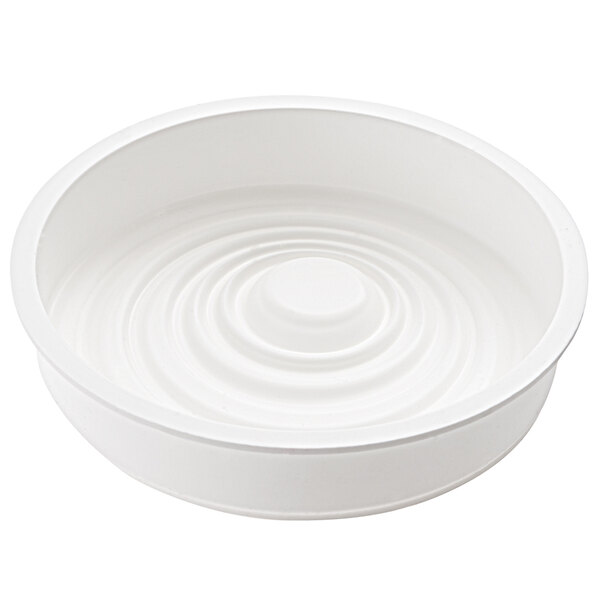 A white silicone baking mold with a ripple design.