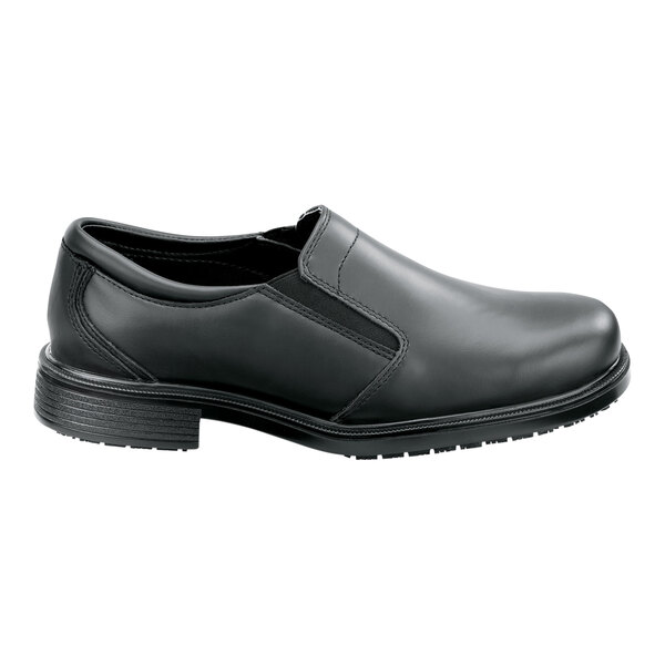 A black men's slip-on dress shoe with a soft toe and non-slip sole, shown in a wide width size 12.
