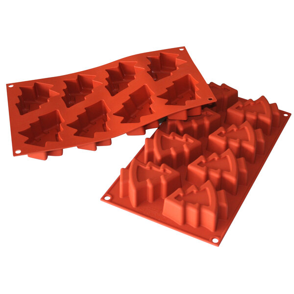 A Silikomart red silicone baking mold with pine tree shapes.