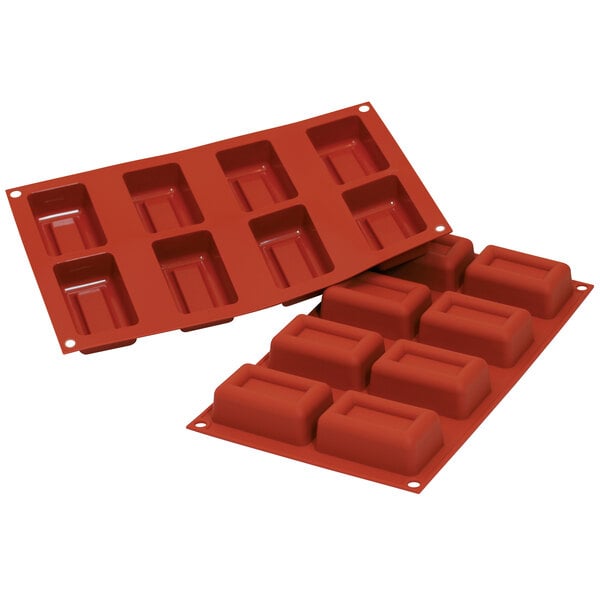 A red Silikomart silicone mold with rectangular compartments.