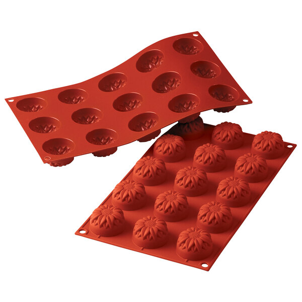 A red Silikomart silicone mold with small sunflower-shaped cavities.