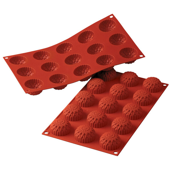 A red silicone mold with 15 small dahlia-shaped cavities.