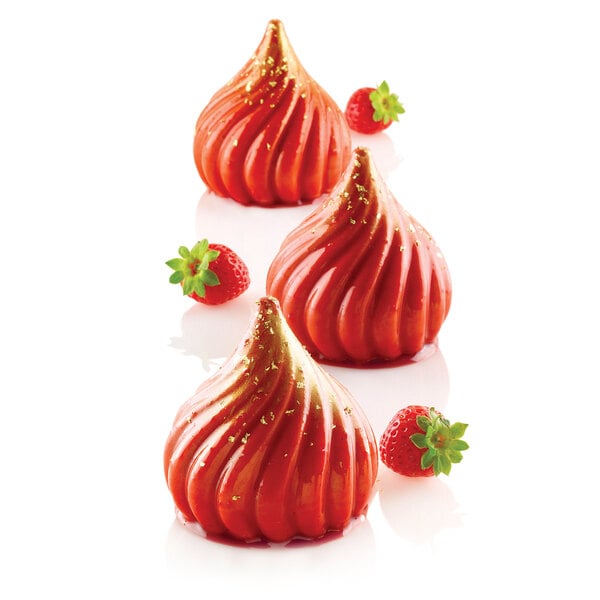 A close-up of a red dessert with a gold swirl.