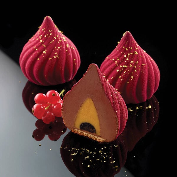 Three red desserts in Silikomart Russian Tale silicone molds on a bakery display.